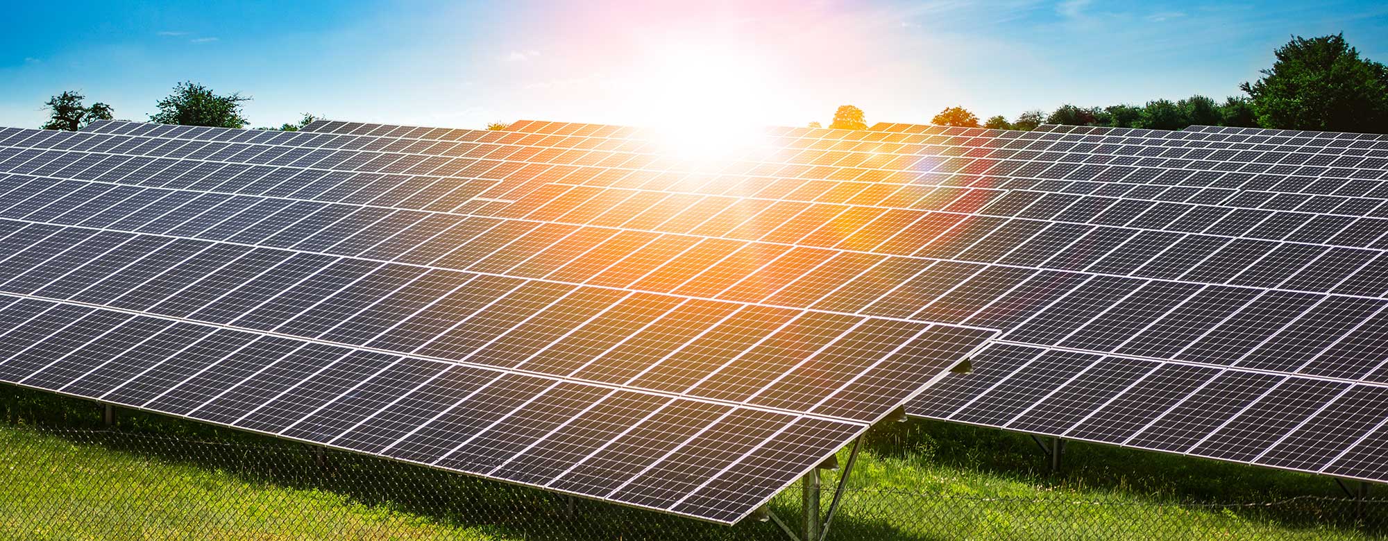 Burst of sunlight shining on solar panels